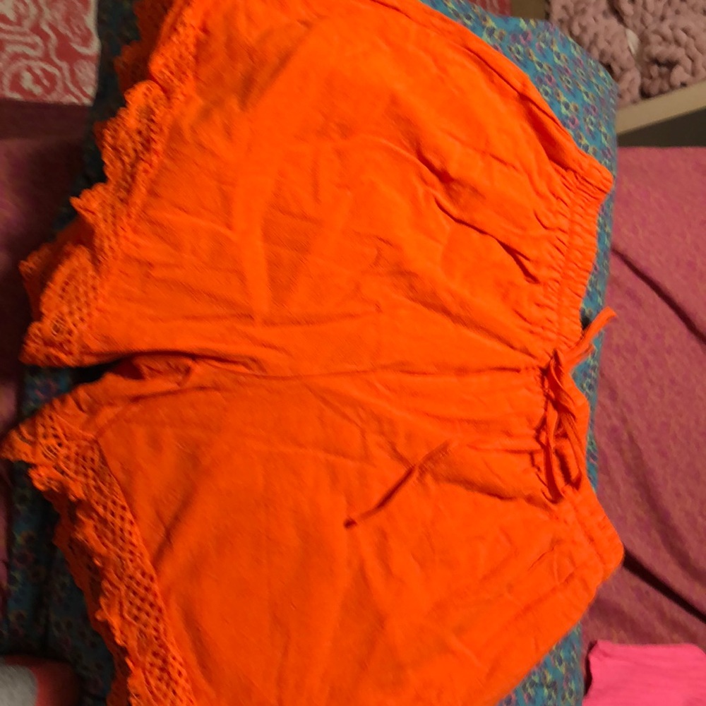 Bright orange shorts with lace trim